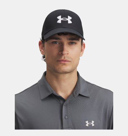 Man wearing a black Under Armour cap and gray polo shirt on a white background